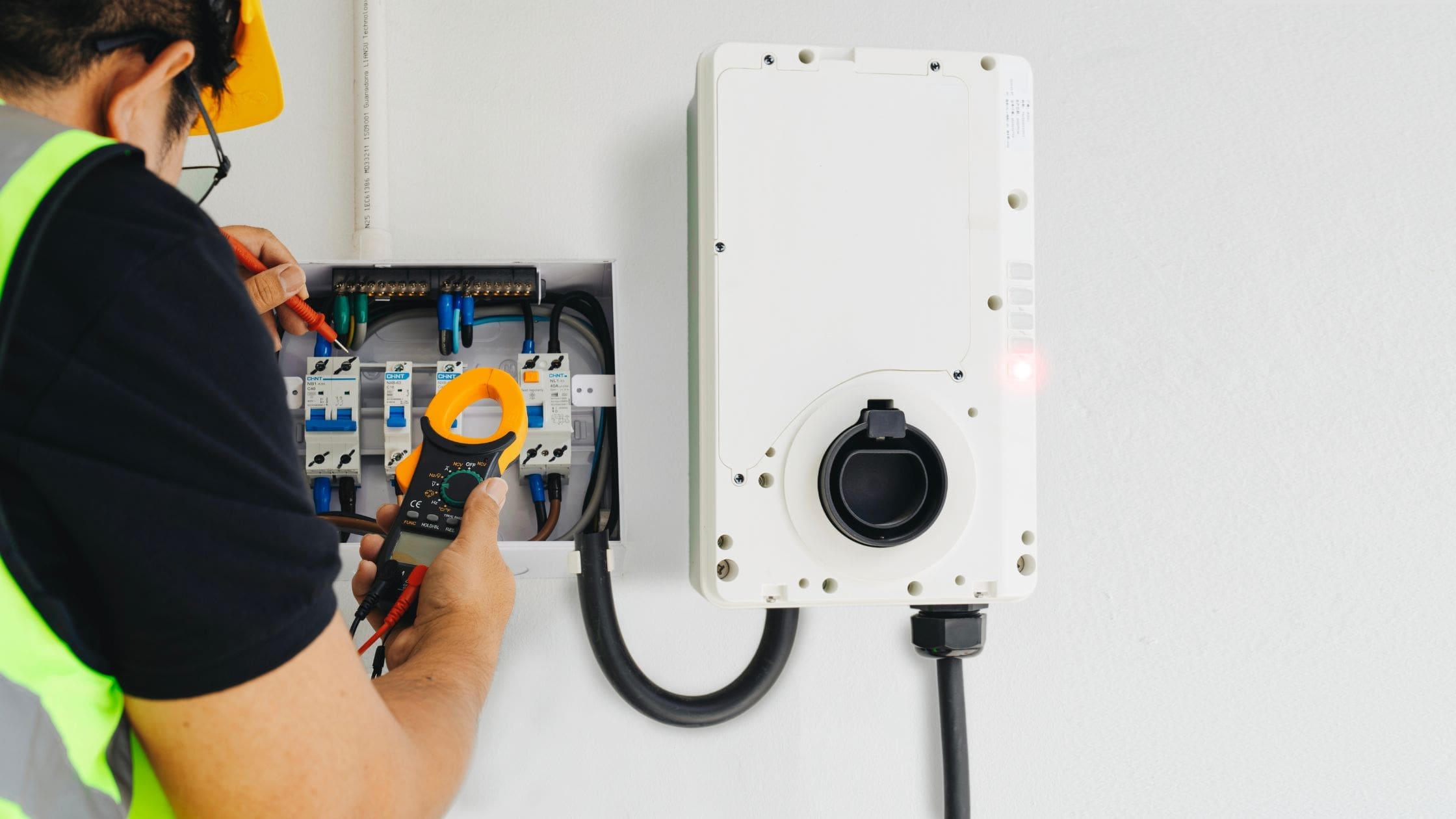 A man installing EV Charger to wall